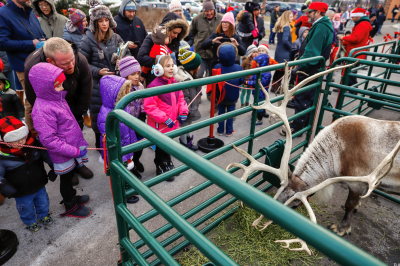 A group of children and adults, dressed warmly in winter attire